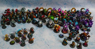 Painted Agemonia hero and enemy miniatures with standees