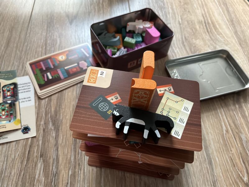 Players building the Bookshelf game structure