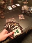 Cahoots card game in play with three players