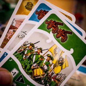 Catherine dual-use action cards held during play