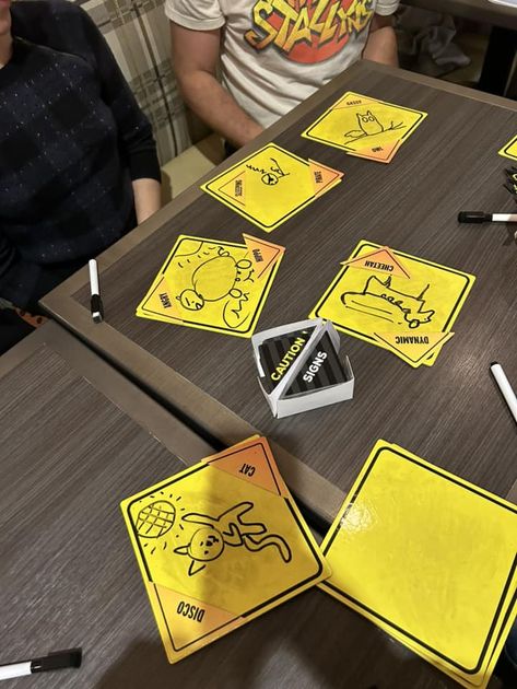 People playing Caution Signs at a table