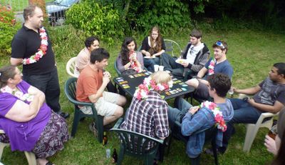 A group playing Cockroach Poker around a table