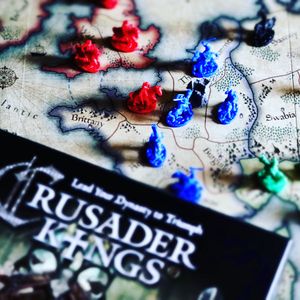 Crusader Kings game board with cards and miniatures