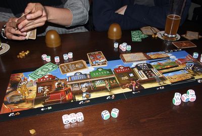 Five players rolling Dice Town poker dice around the board