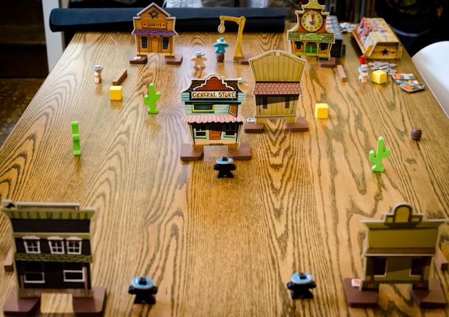 Flick 'em Up wooden cowboys and Western town in play