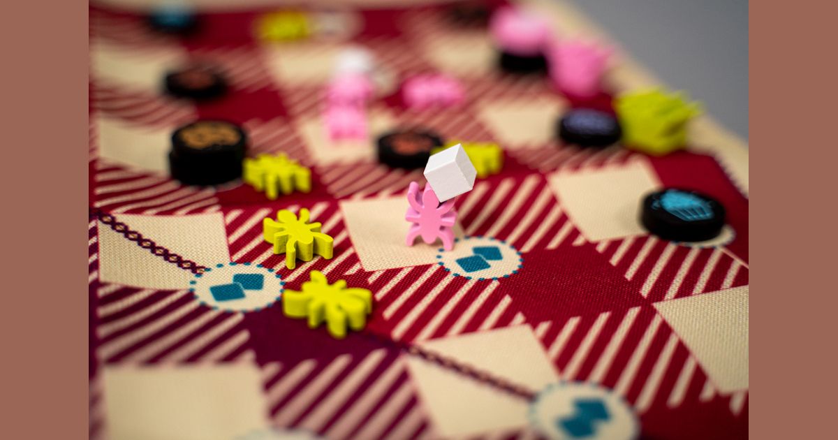 Gingham ant pieces connected across the cloth board
