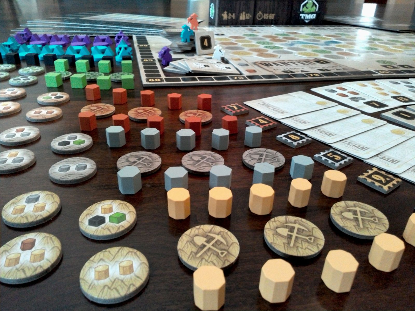 Gold West resource pieces and player supply board close up