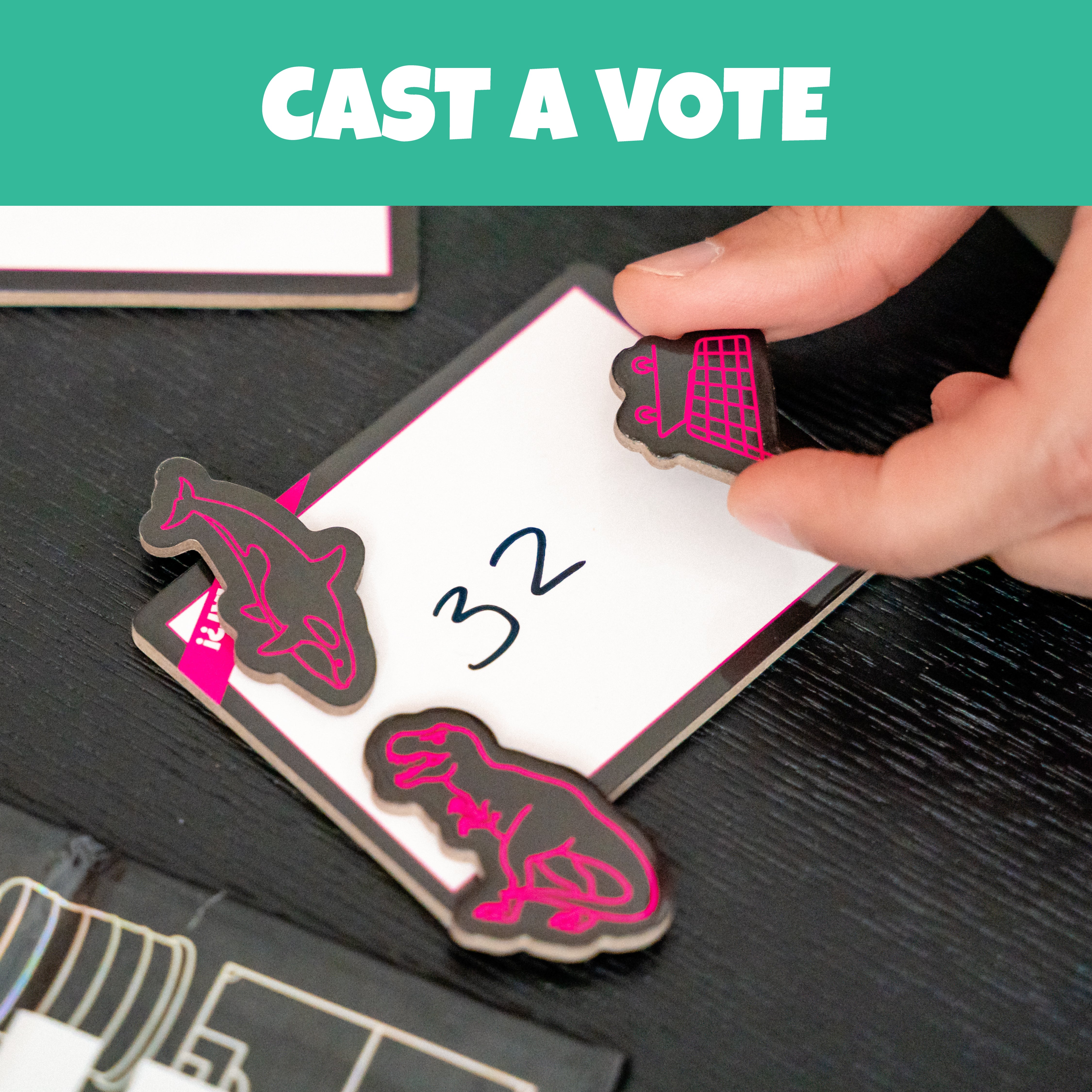 Illustrated voting tokens placed beside a dry-erase guess