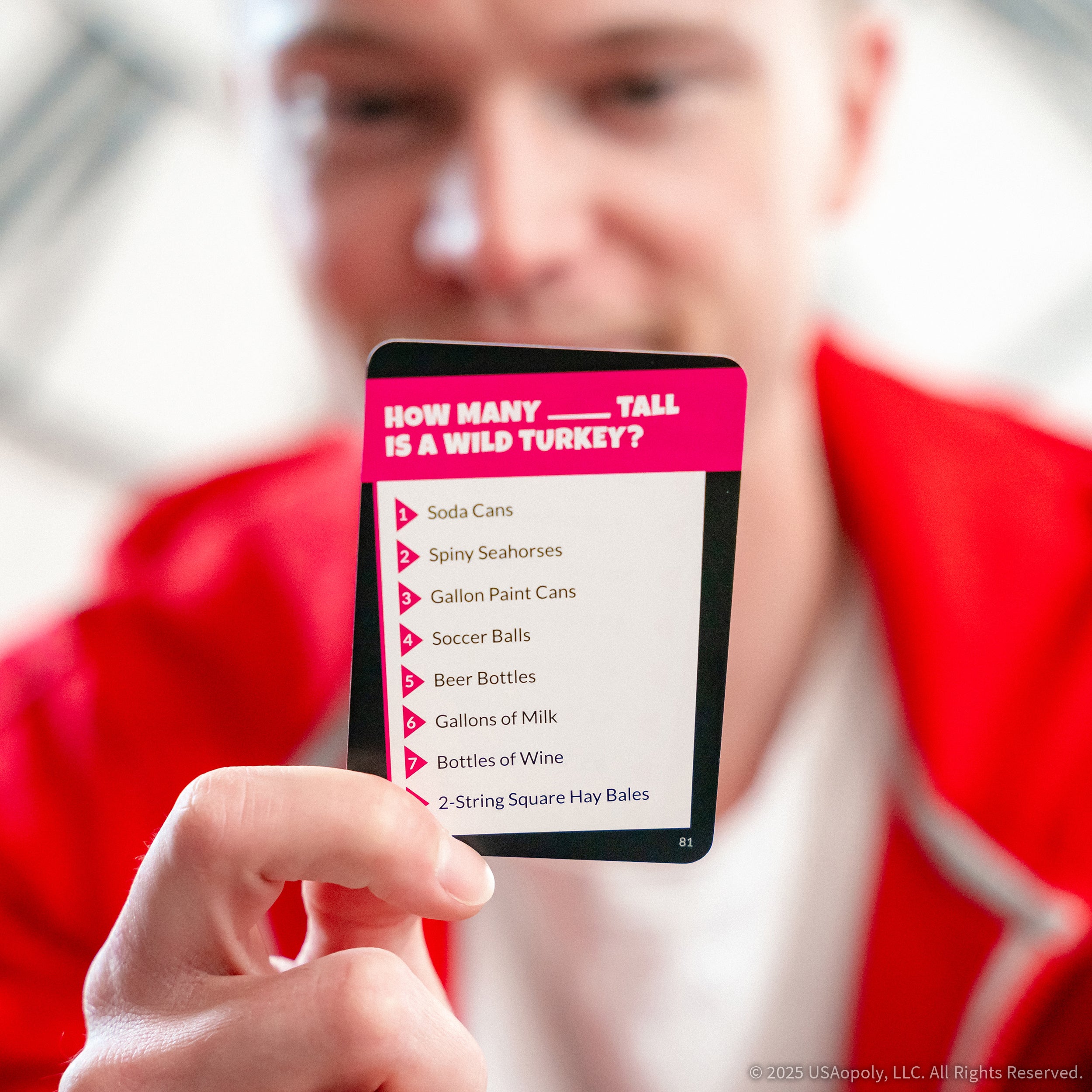 Player reading a How Many What question card