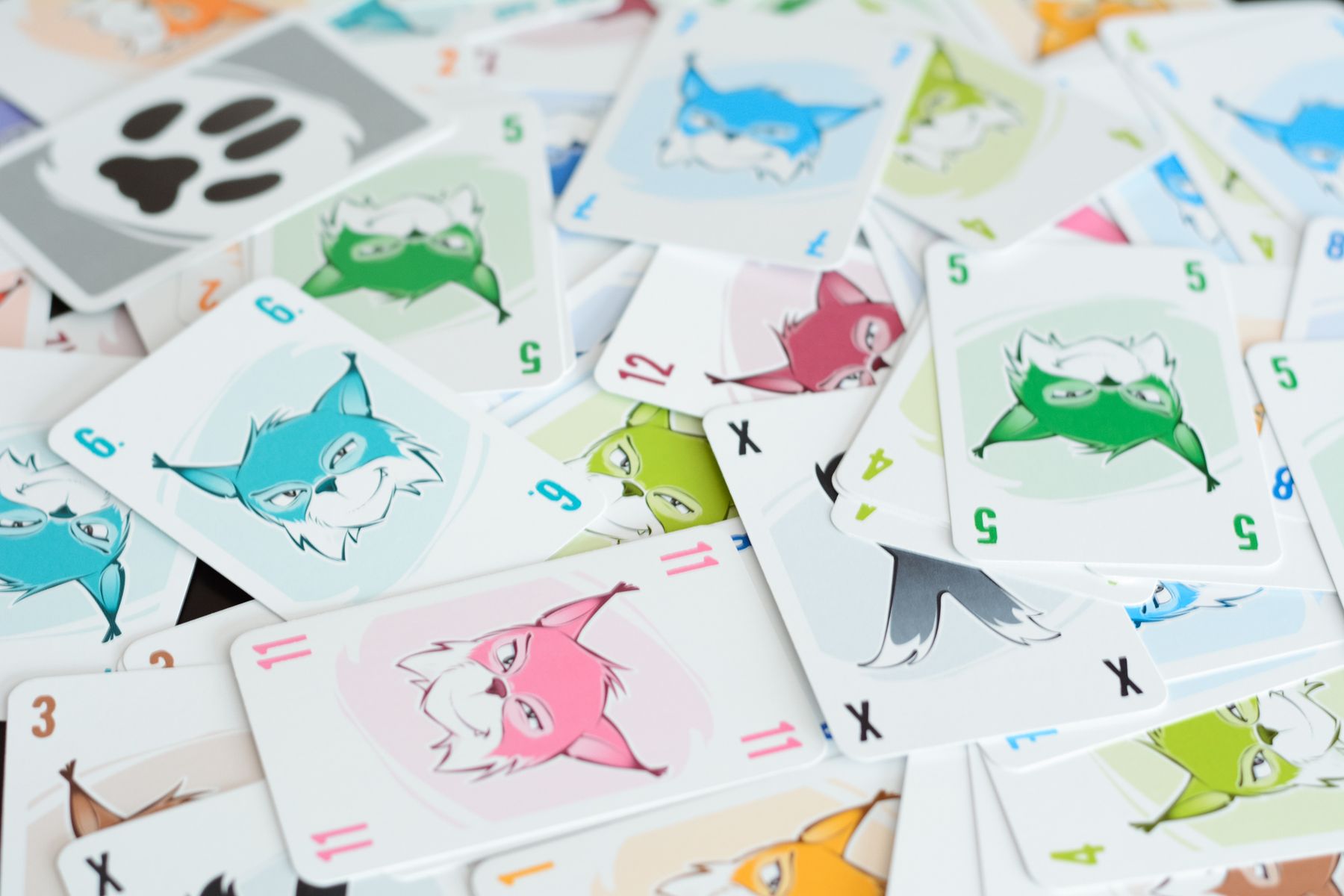 Linko cards spread across a tabletop showing numbers and illustrations
