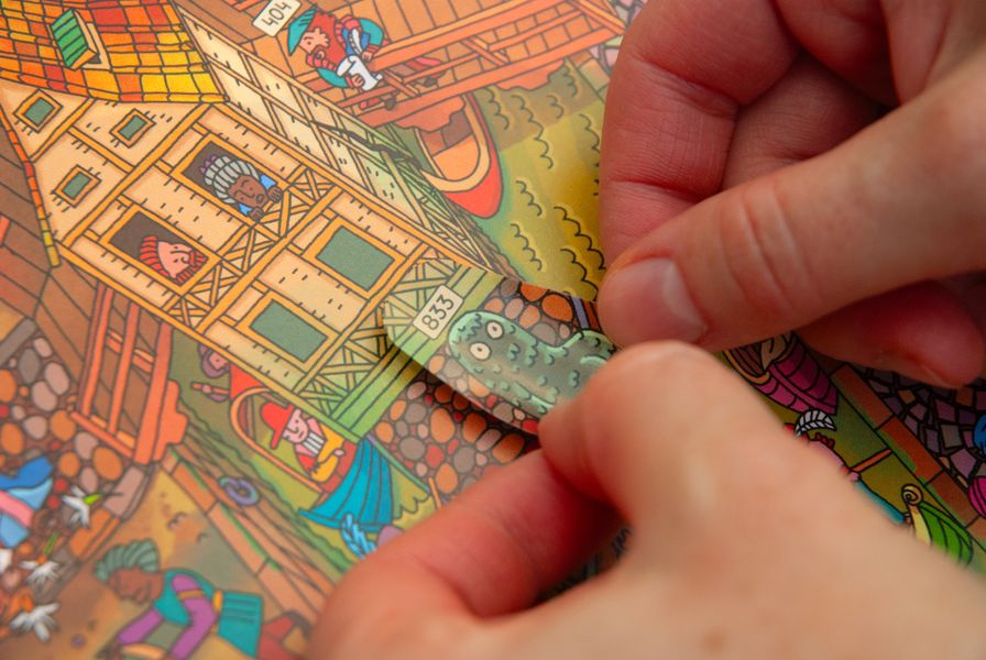 Player applying a sticker in Miasto Tańczącego Karpia
