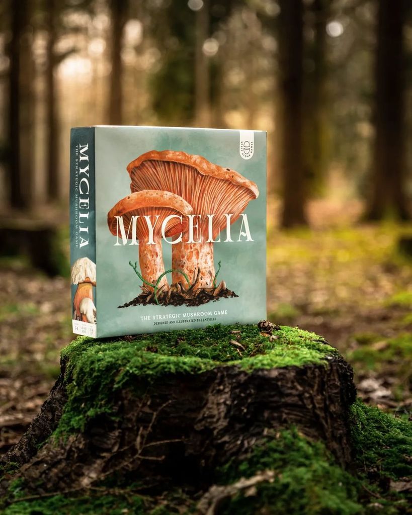 Mycelia board game box photographed in woodland