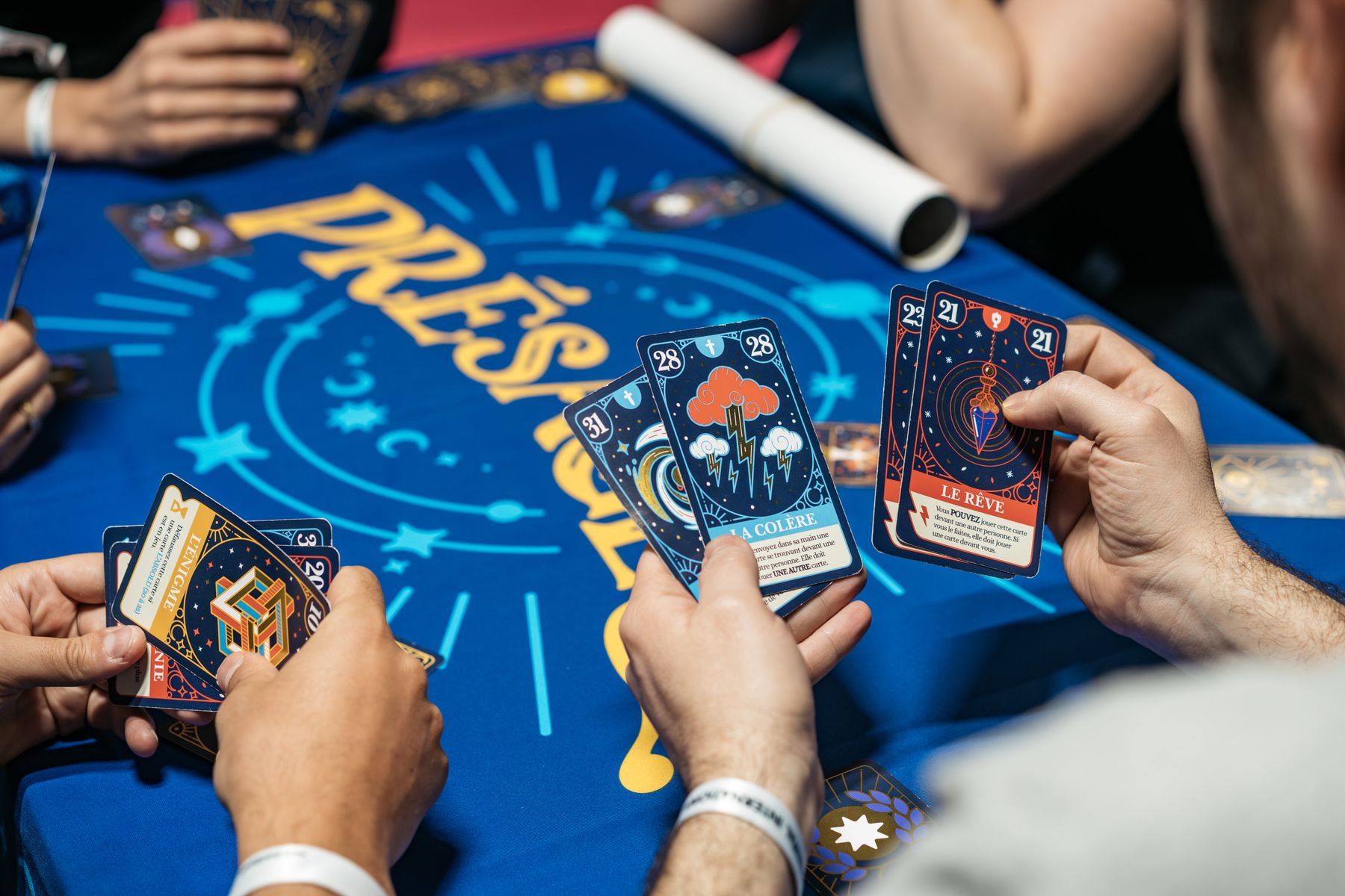 Players learning Omens at a game festival table