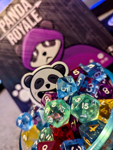 Panda Royale dice collected in a drafting bowl