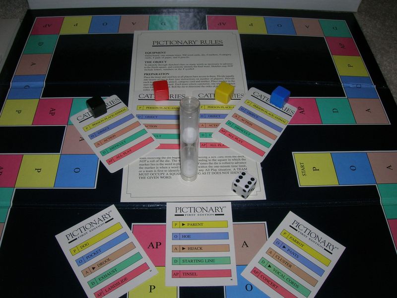 Pictionary board timer and cards on a table