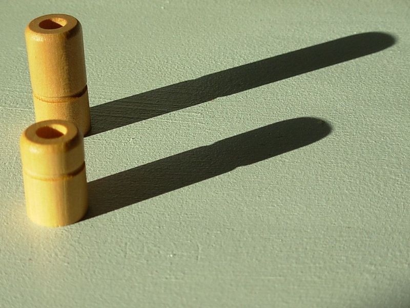 Quarto wooden pieces photographed in afternoon light