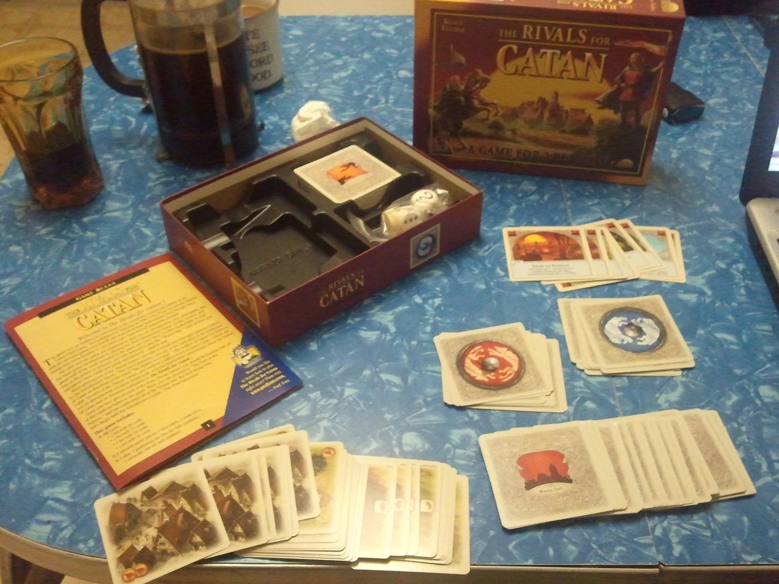 Rivals for Catan cards dice and tokens arranged on a table