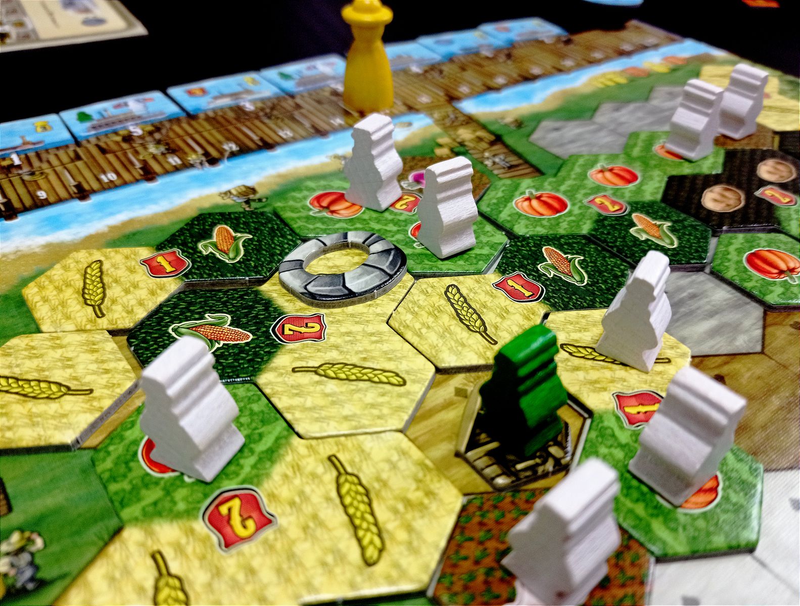 Riverboat game close up showing boats cards surveyors and crop tiles