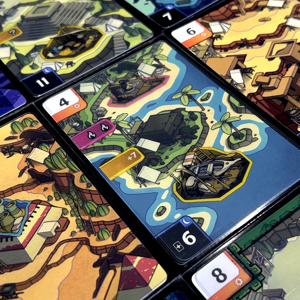 Ruins card game arranged on a table with components