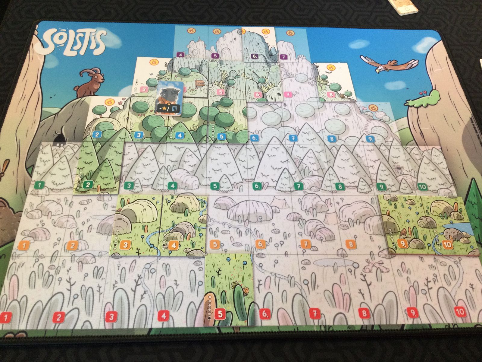 Solstis landscape tiles arranged on a playmat