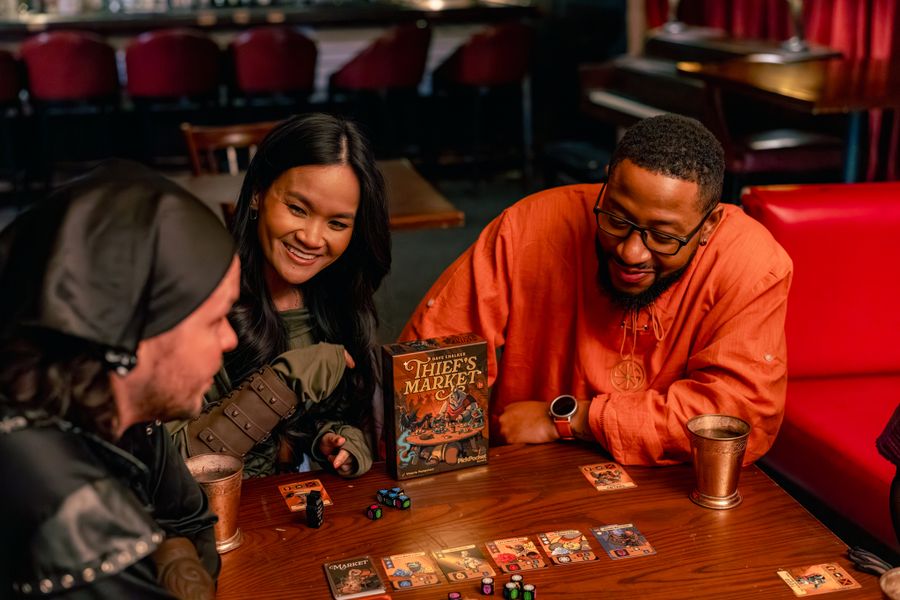 Thief's Market cards coins and dice during play