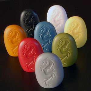 Colorful Tsuro player stones beside path tiles