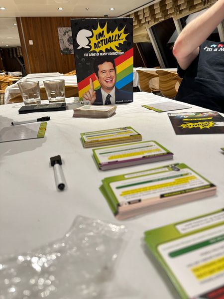 People playing Um Actually at a board game event