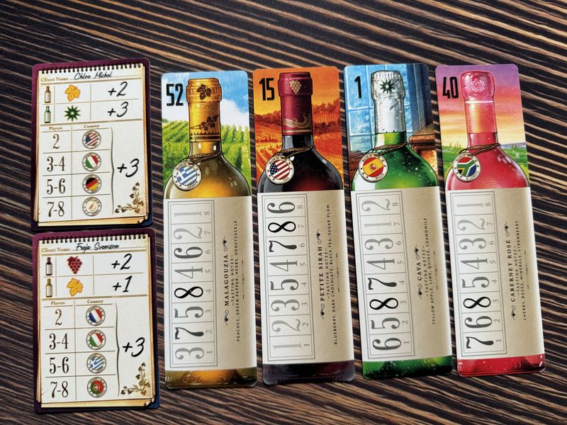 Wine Cellar auction cards and player areas on a table