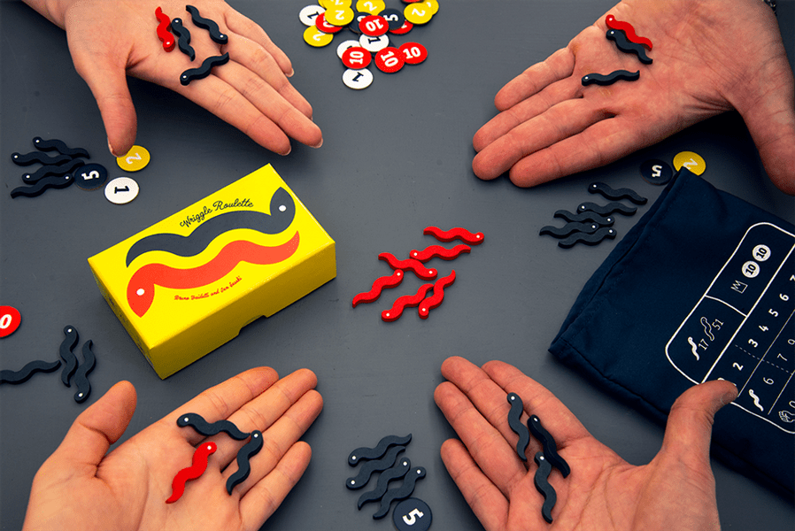 Players drawing wooden pieces from the Wriggle Roulette bag