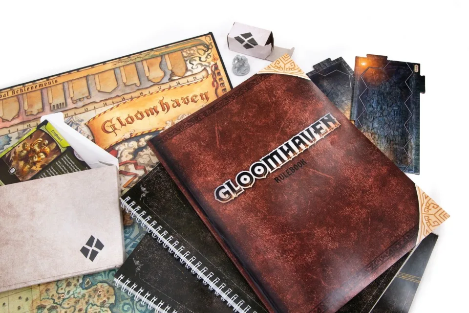 Gloomhaven rulebook, scenario books, campaign map, character materials, and map tiles