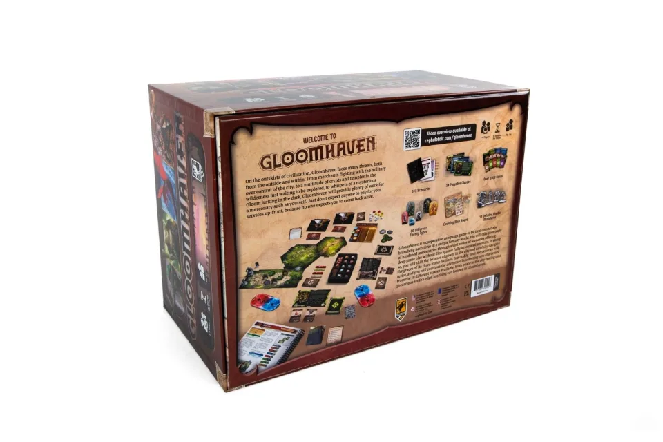 Gloomhaven components arranged with books, cards, tiles, and tokens