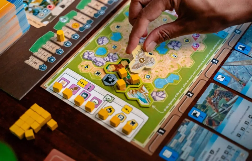 Close-up of an Ark Nova zoo map with enclosure tiles and player markers