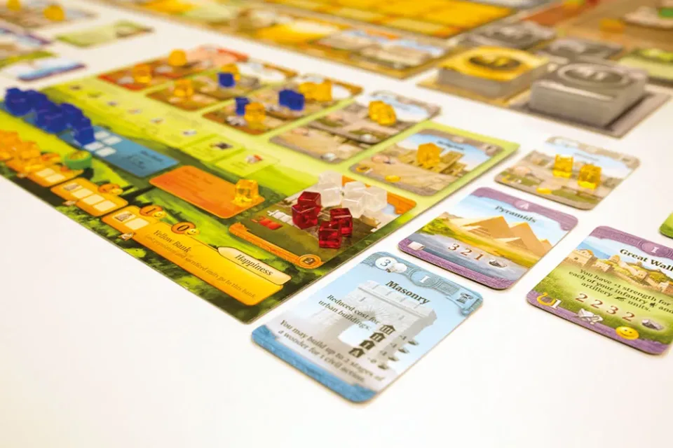 Close-up of Through the Ages player board with cards and cubes