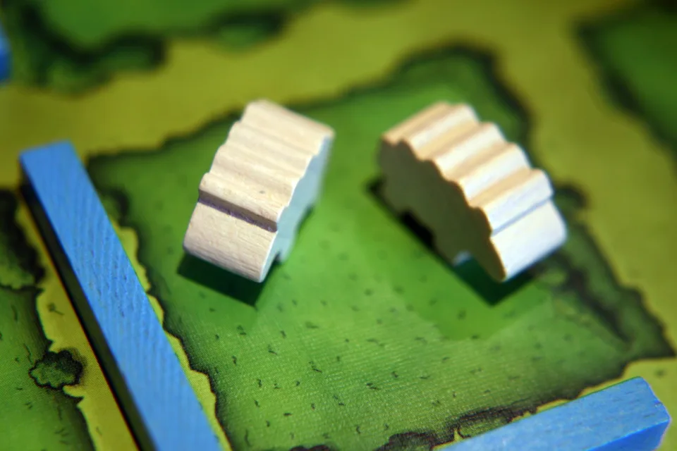 Agricola player farm board with family and resource pieces.
