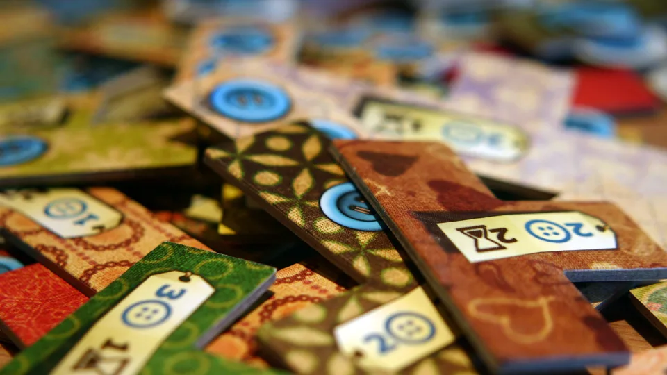 Patchwork fabric-shaped patch tiles with printed button and time costs.