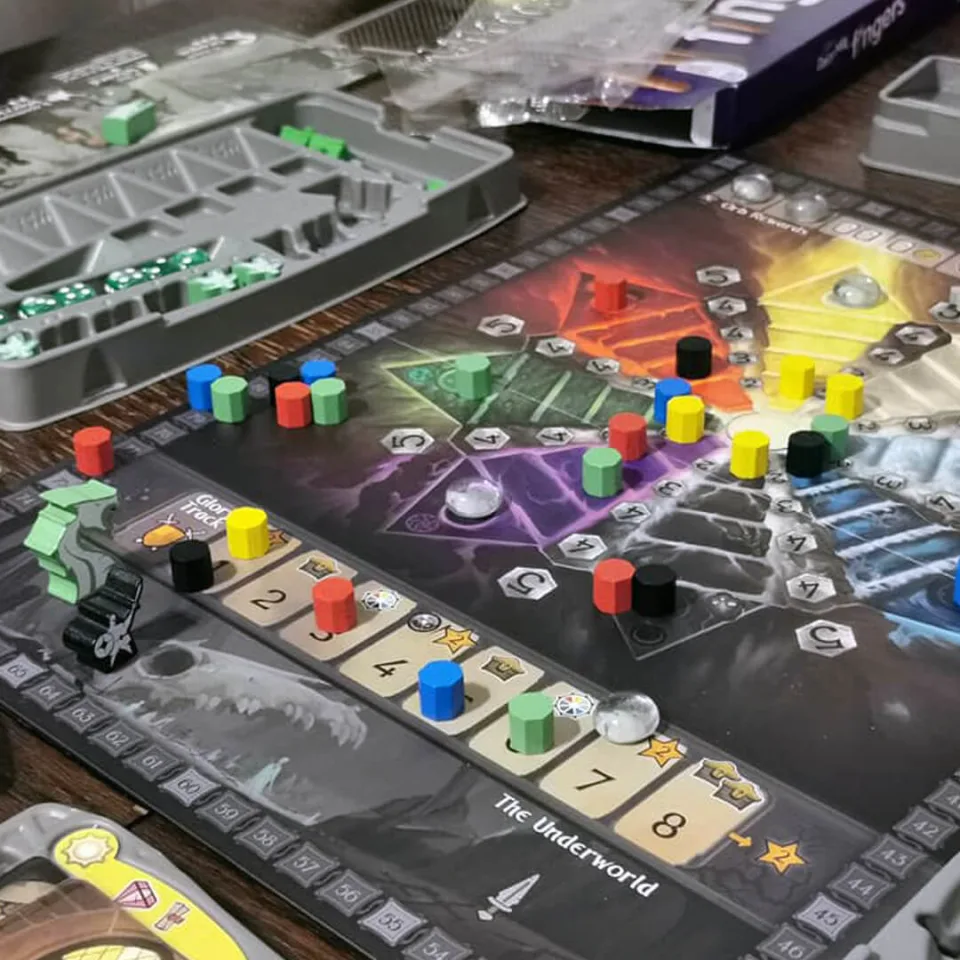 Dwellings of Eldervale board in play with elemental realms, dwellings, workers, score track, and storage trays.