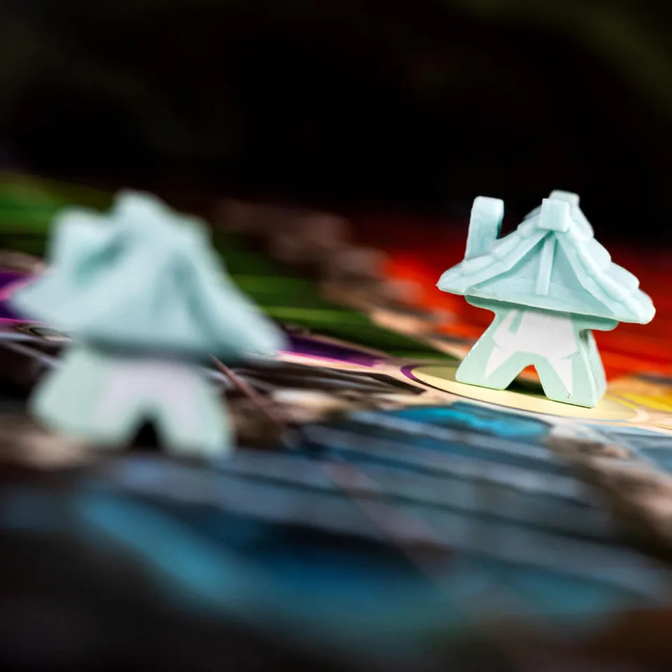 Dwellings of Eldervale wooden dwelling pieces on the game board.