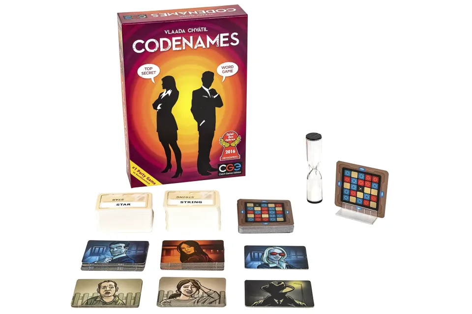 Players seated around a Codenames game in progress.
