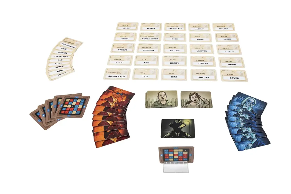 Codenames game set up on a table with a word-card grid.