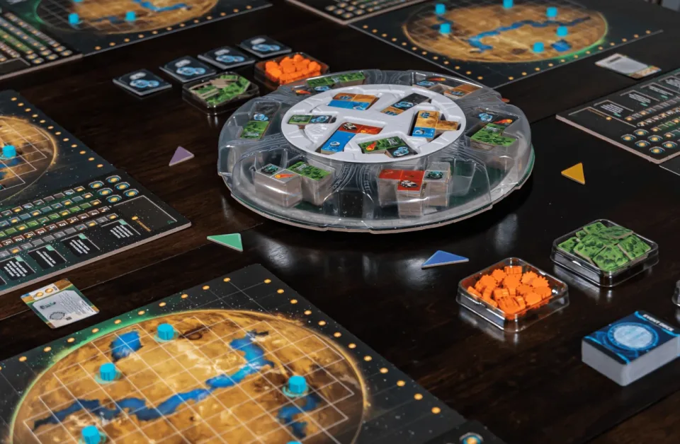 Planet Unknown set up on a table with player boards and Lazy Susan.
