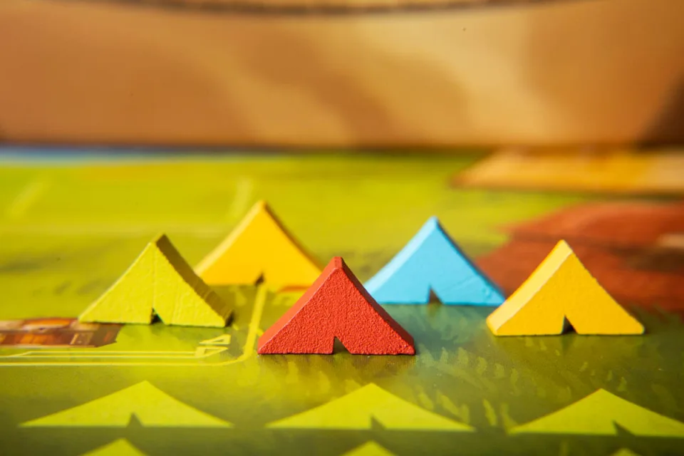 Colored camp markers positioned on a Near and Far adventure map.