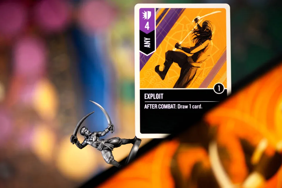 Unmatched Battle of Legends cards, miniatures, and board game components.