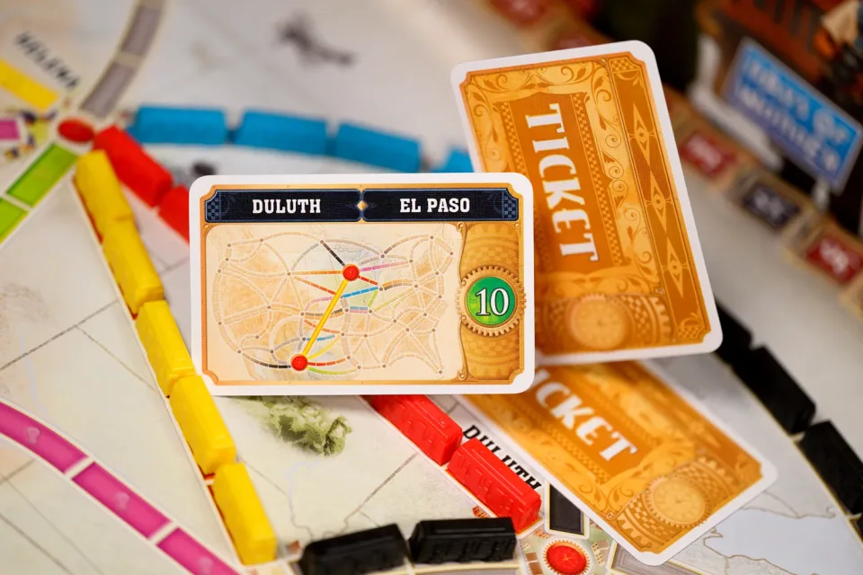 Ticket to Ride destination ticket and train pieces on the board